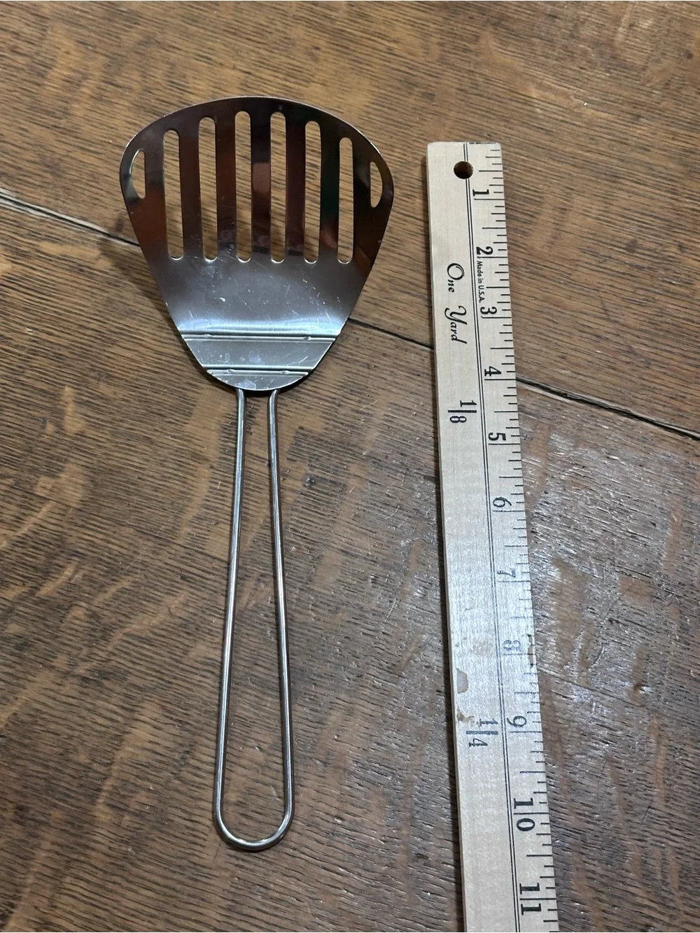 vintage metal slotted fryer scoop or spatula, commonly used with deep fryers